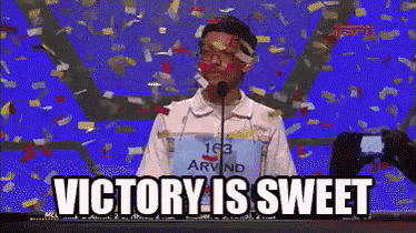 a man stands in front of a microphone with confetti falling around him and the words " victory is sweet " written below him