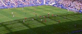 a soccer game is being played in a stadium with a lot of people watching .