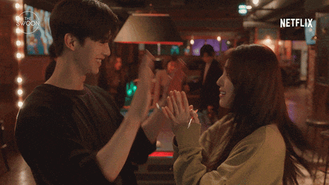 a man and a woman are giving each other a high five with netflix written on the bottom