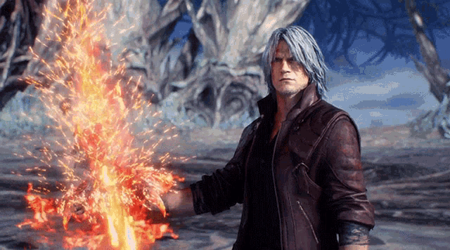 a man in a leather jacket is holding a sword of fire in his hands .