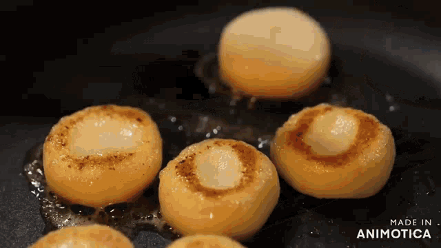 a bunch of food is being cooked in a pan and the words made in animotica are on the bottom