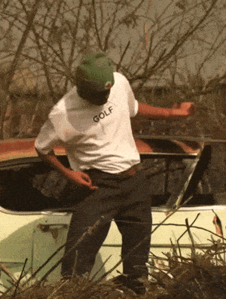 a man wearing a white golf shirt is dancing in front of a car