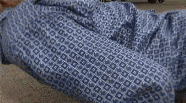 a person is laying on the ground with a woman 's foot on their chest