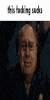 a close up of a bald man 's face with the words `` this fading away '' written above him .