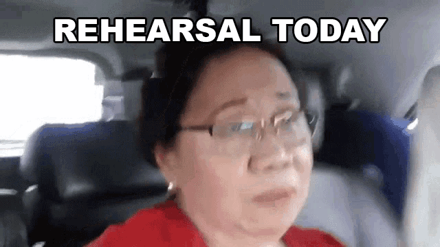 a woman with glasses is sitting in the back seat of a car with the words rehearsal today above her