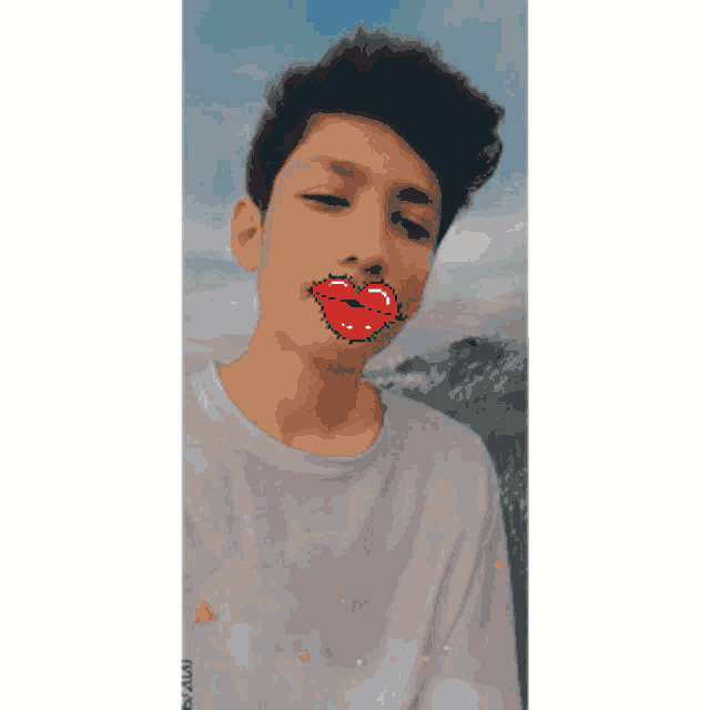 a young man wearing a white shirt has a pixel art of a kiss on his lips