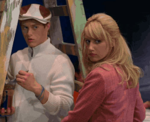 a woman in a pink jacket looks at a man in a white jacket