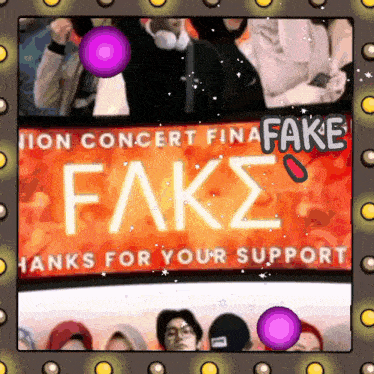 a group of people sitting in front of a banner that says fake