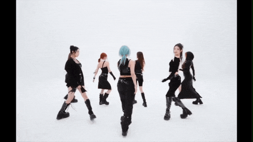 a group of women are dancing in front of a white wall