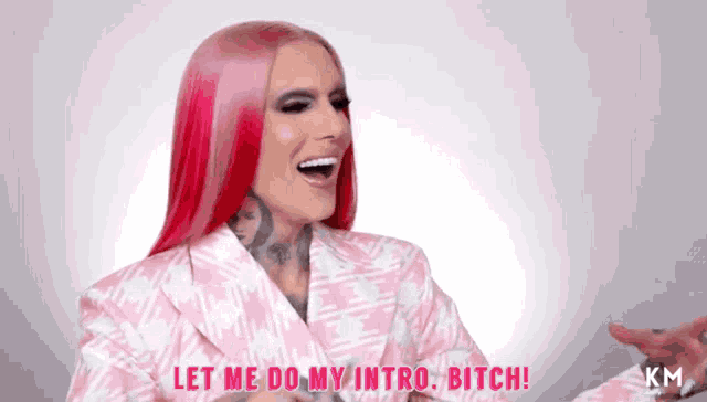 a woman with red hair is laughing and saying let me do my intro bitch