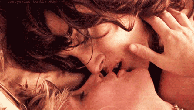 a couple kissing with a tumblr.com watermark on the bottom right
