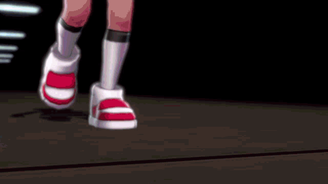 a person wearing a pair of red and white sneakers with the number 8 on the sole
