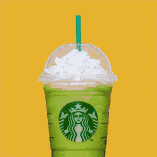 a starbucks cup with whipped cream and a straw