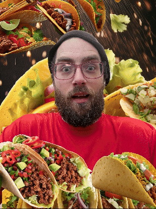 a man with glasses and a beard is surrounded by lots of tacos
