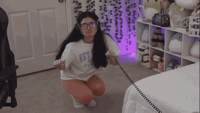a woman wearing headphones and a key shirt
