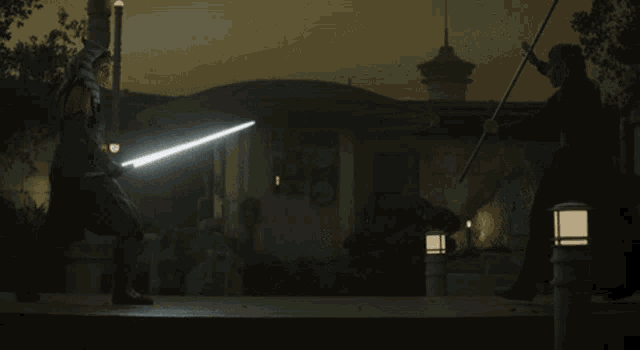 two people fighting with lightsabers in the dark