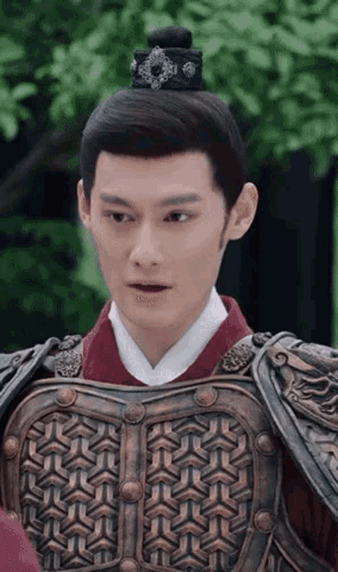 a man wearing armor and a hat is making a surprised face
