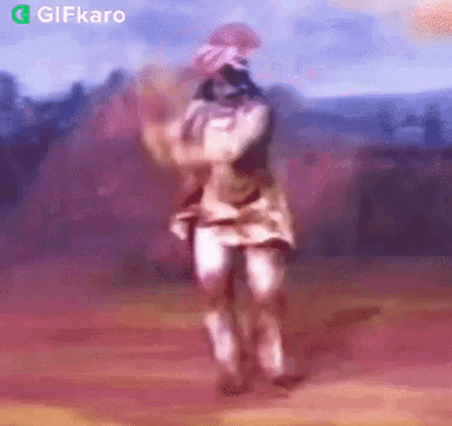a blurry picture of a person dancing with the words gifkaro in the corner