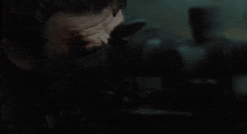 a close up of a man looking through a sniper scope