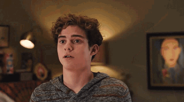a man with curly hair is making a funny face