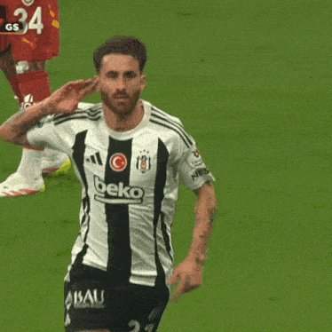 a soccer player wearing a black and white jersey with beko on it