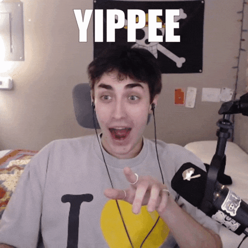 a young man wearing headphones and a shirt that says i love you is pointing