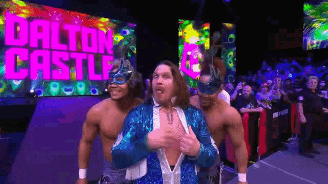a group of wrestlers are standing in front of a sign that says dalton castle on it