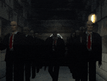 a group of bald men in suits and ties are standing in a line