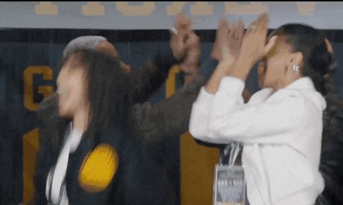 a group of people giving each other a high five