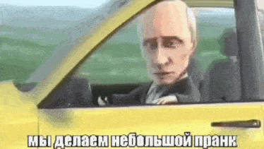 a man in a suit and tie is driving a yellow car with a cartoon head sticking out of the window .