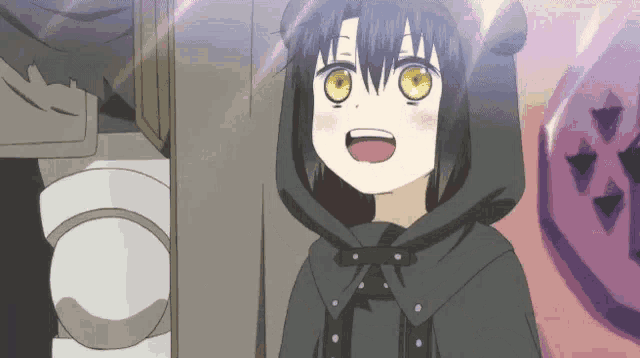 a little girl with yellow eyes is wearing a black hooded cape