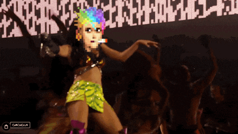 a woman is dancing in front of a screen that says coachella on it