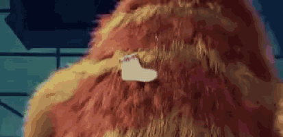 a close up of a stuffed animal 's fur with a white sticker on it .