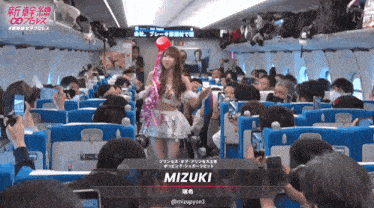 a woman on a plane with the name mizuki written on the bottom