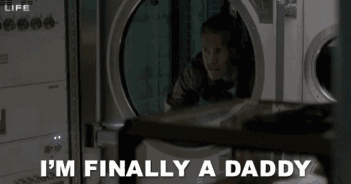 a man peeking out of a washing machine with the words i 'm finally a daddy below him