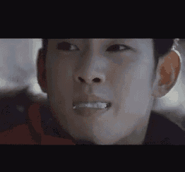 a close up of a person 's face with a toothbrush in his mouth