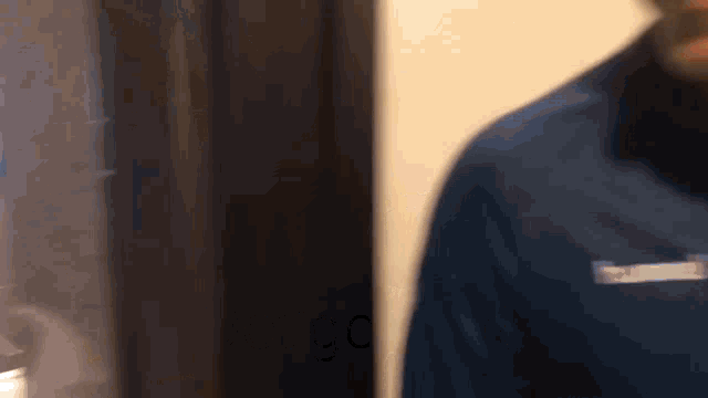 a man in a blue jacket has a pocket that says ' columbia '