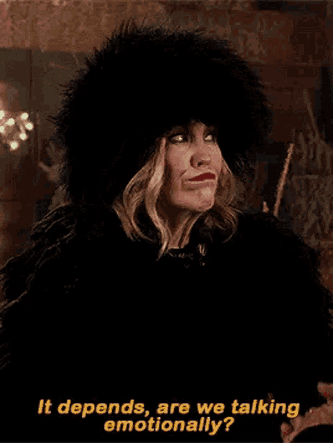 a woman wearing a fur hat and a black coat is talking to someone .