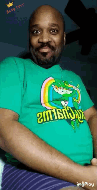 a man wearing a green shirt that says betty boop on it