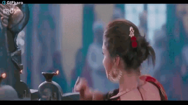 a woman is standing in front of a mirror and looking at herself in a mirror .