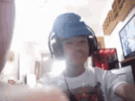 a boy wearing headphones and a blue hat with ny on it