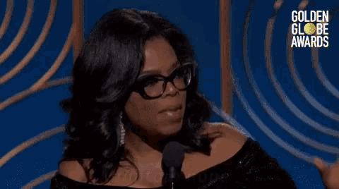 oprah winfrey is speaking into a microphone at the golden globes awards and says maintain hope .