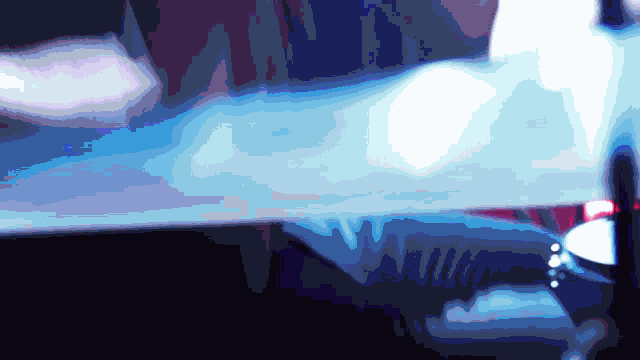 a blurry image of a person 's face with a blue light behind them