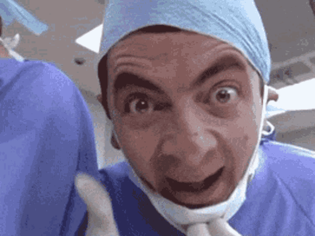 a surgeon is making a funny face while wearing a surgical mask and gloves .