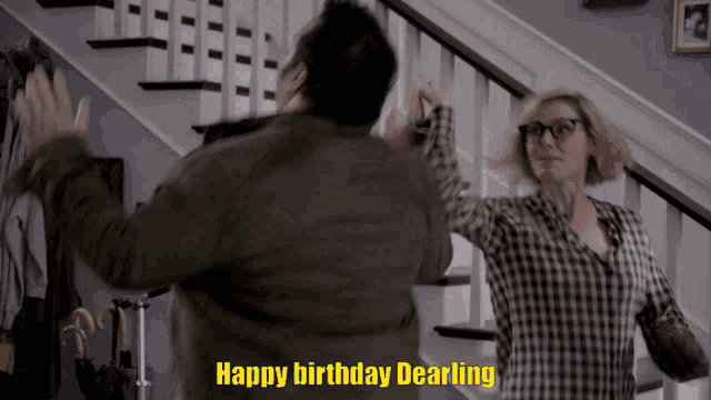 a man and woman are dancing in front of a staircase with the words happy birthday dearling written in yellow