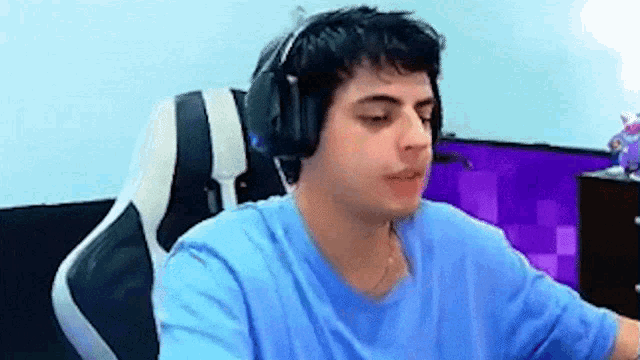 a young man wearing headphones is sitting in a chair .