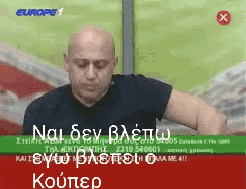 a man is sitting in front of a screen that says europe 1 on it