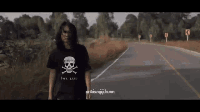 a man in a black shirt with a skull and crossbones on it