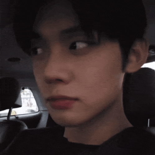 a close up of a person 's face in a car seat