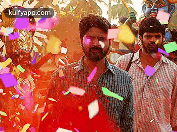 a man with a beard is surrounded by confetti and a statue of a deity .